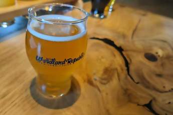 Image of a Woodland Republic beer on a counter.